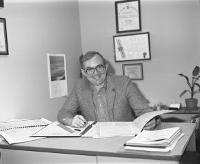 A black and white photo of Dr. Jager at his desk.