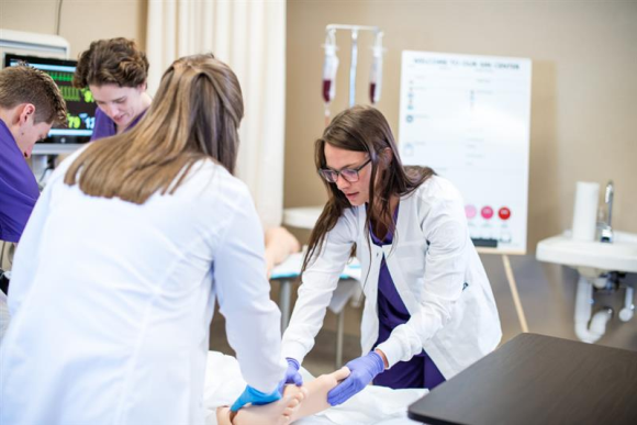 Stock photo of nursing students working in the SIM lab