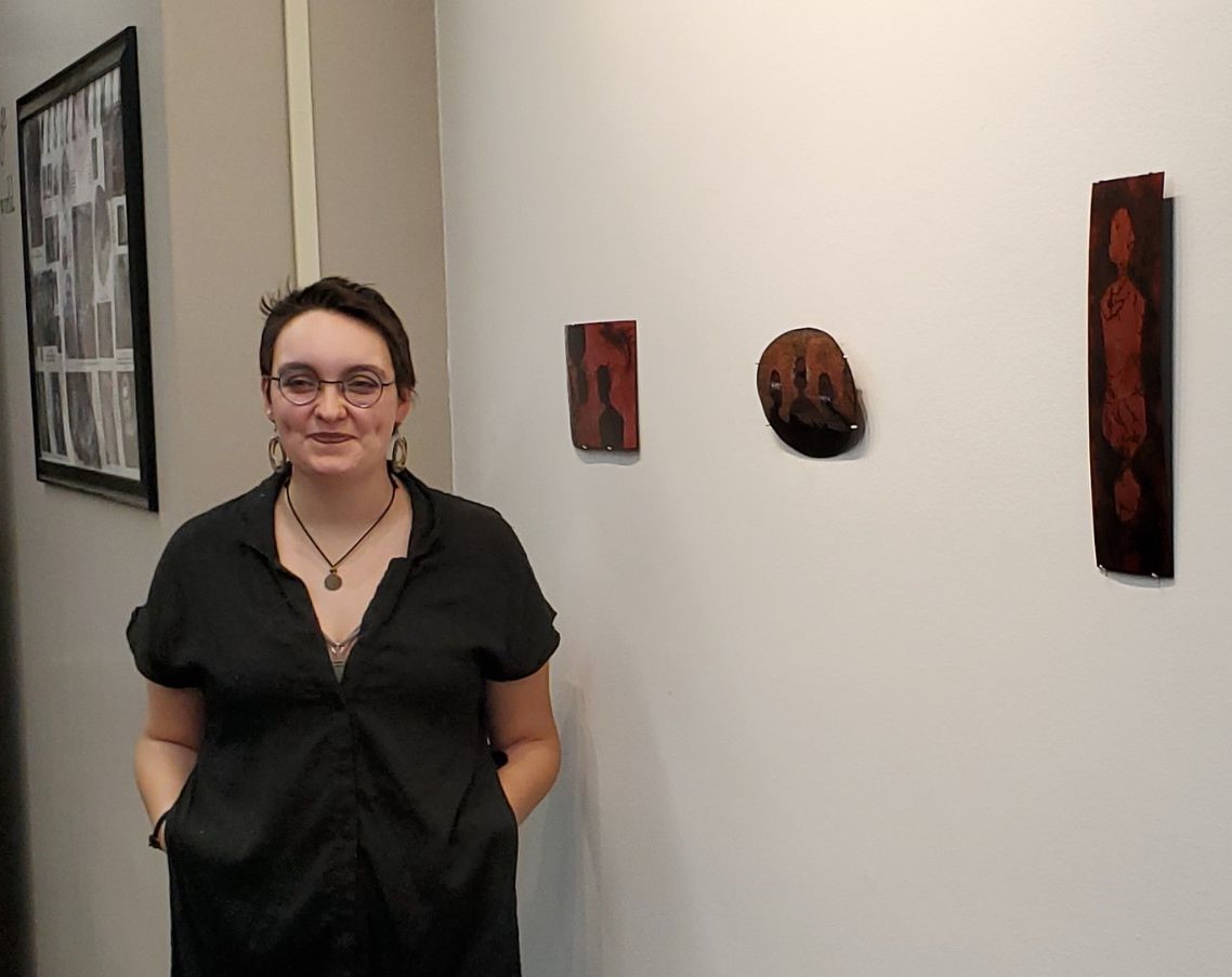 Anna Grayson poses with their exhibit