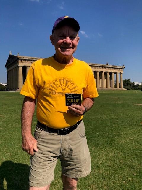 Jackie Corbin stands in front of the Parthenon in Nashville. He is holding his 21 Years True To Tech magnet!