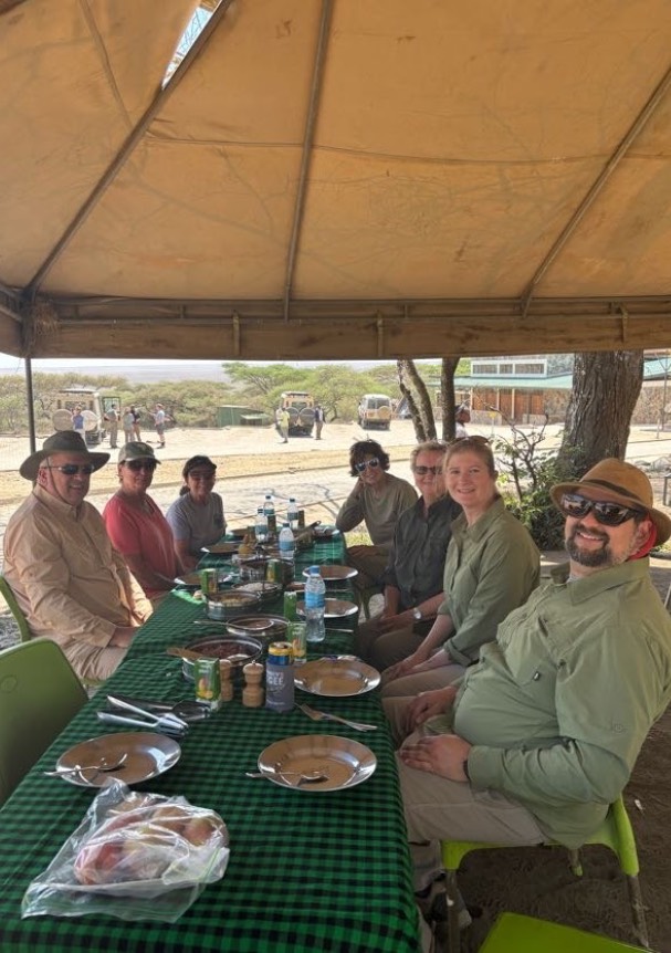 group of peoople sitting under tent
