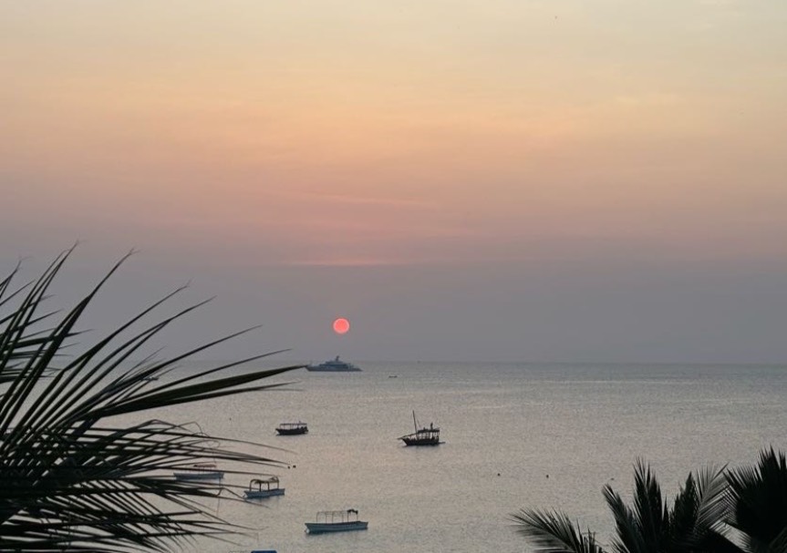 sunset on water with boats