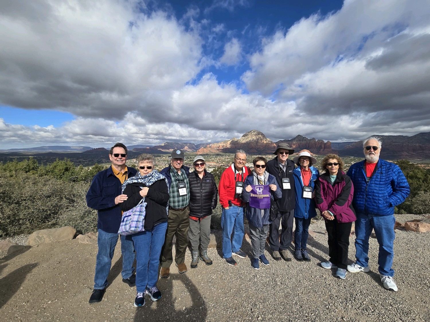 Travelers to the Grand Canyon in front of a vista of red rock