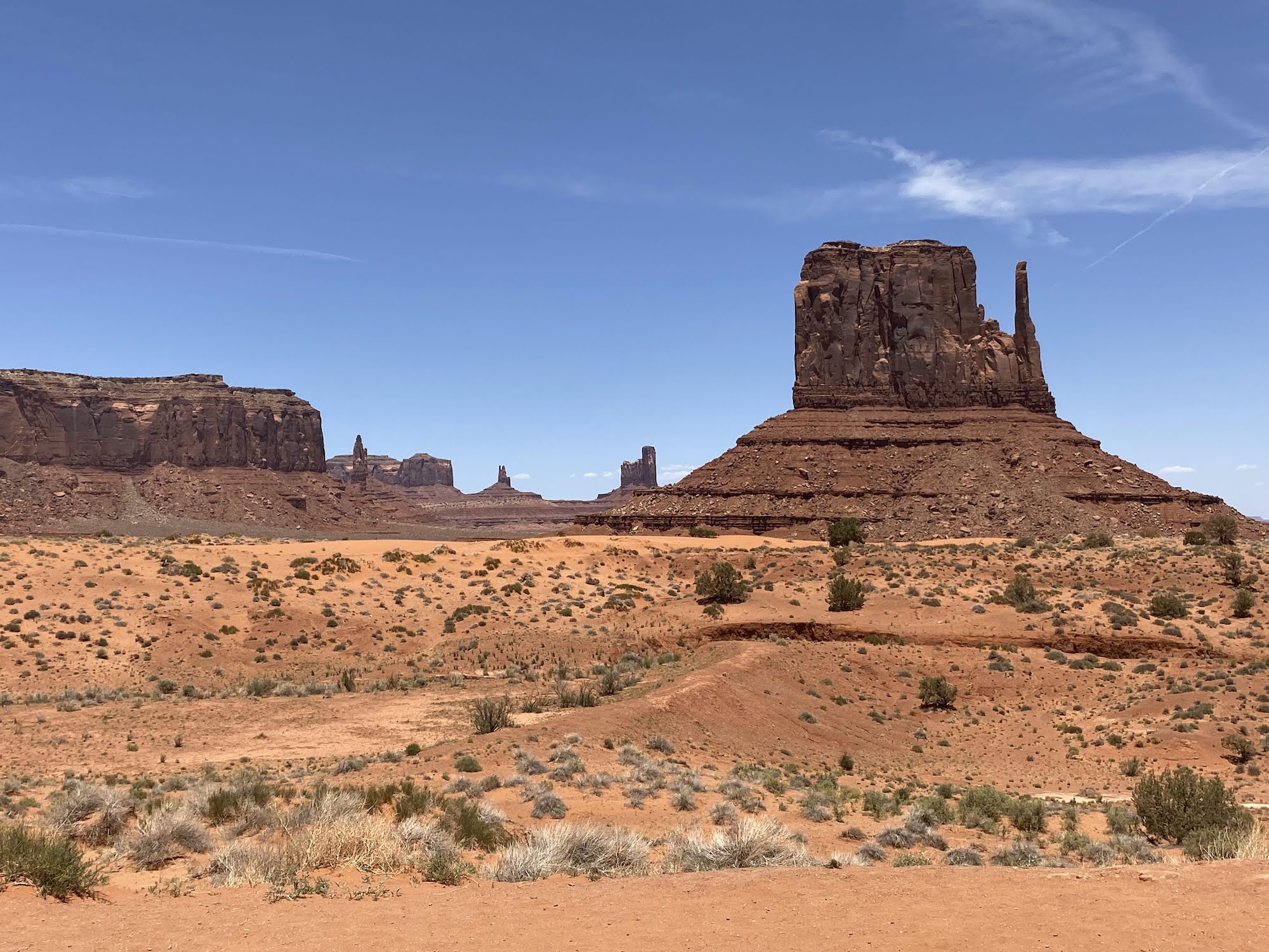 Brown monoliths of rock tower over the red sand desert