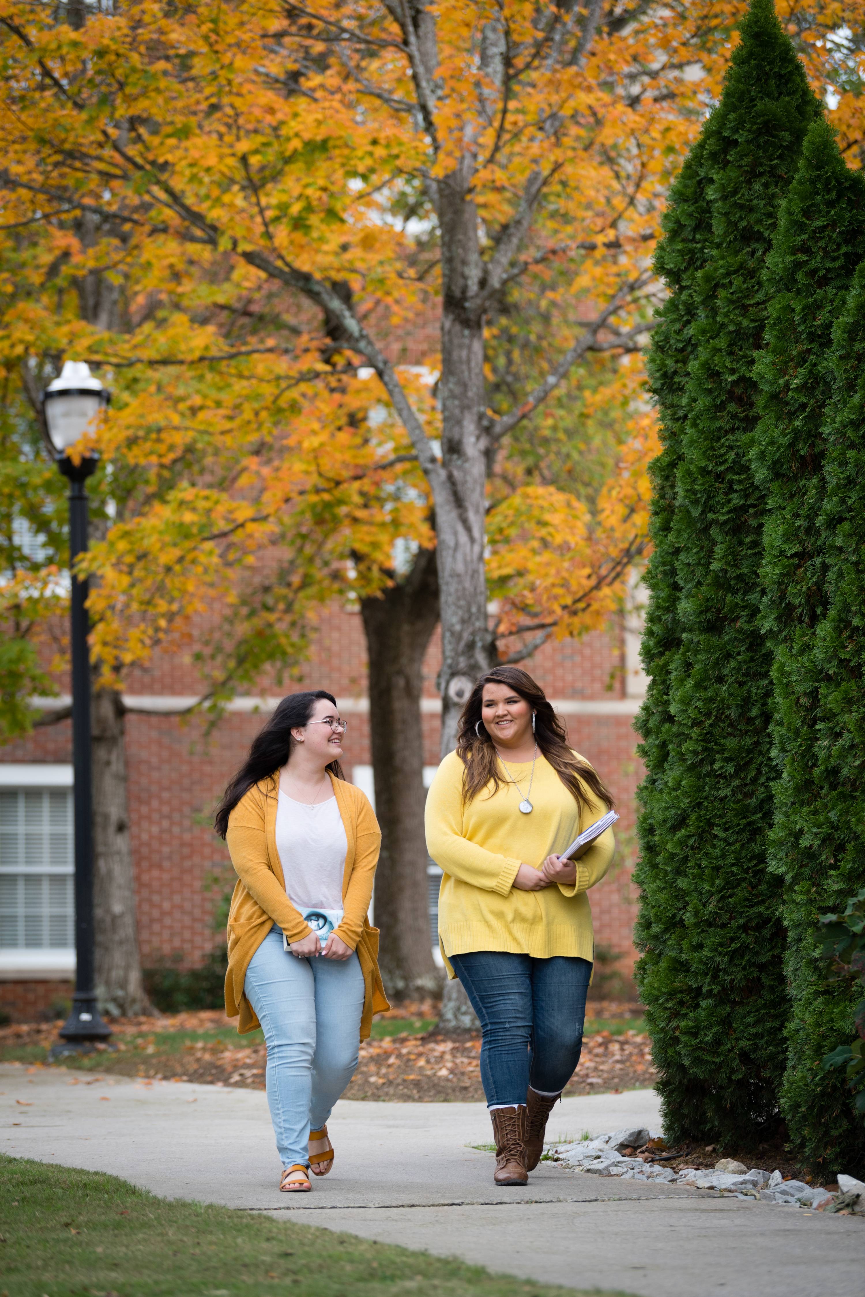 Two women walking in the fall color
